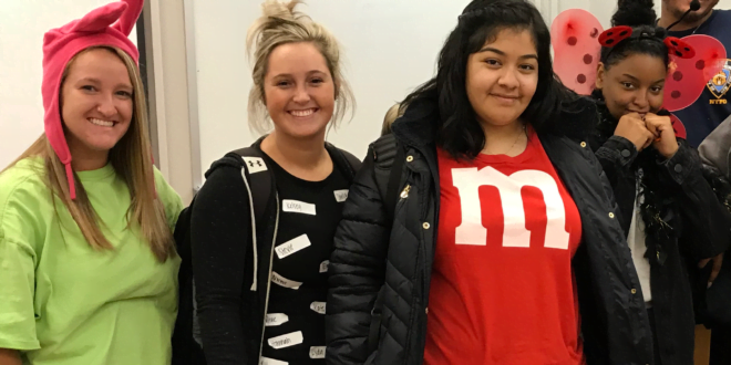 Maggie Granados (M&M shirt) poses with others for Halloween.