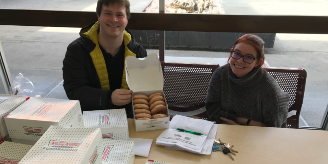 Haven Thompson and Michael Clarke sell donuts for PRSSA.