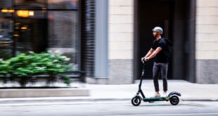 Person riding a VEO scooter.