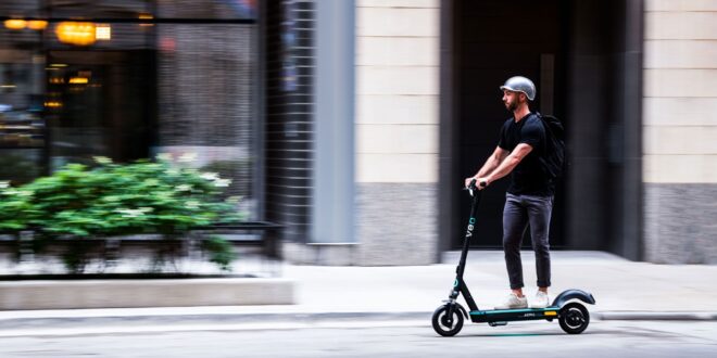 Person riding a VEO scooter.